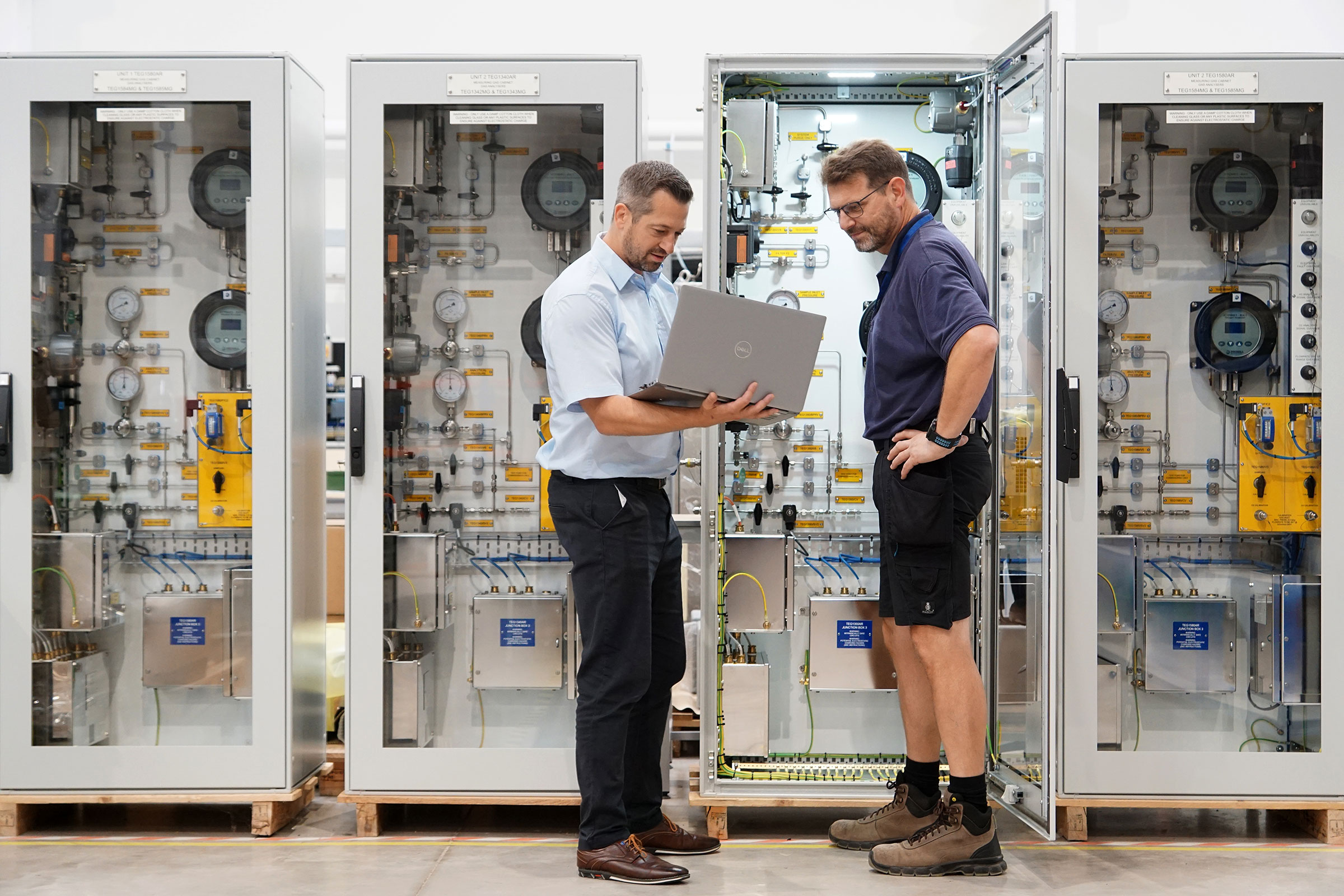 AMS employees working on panel system